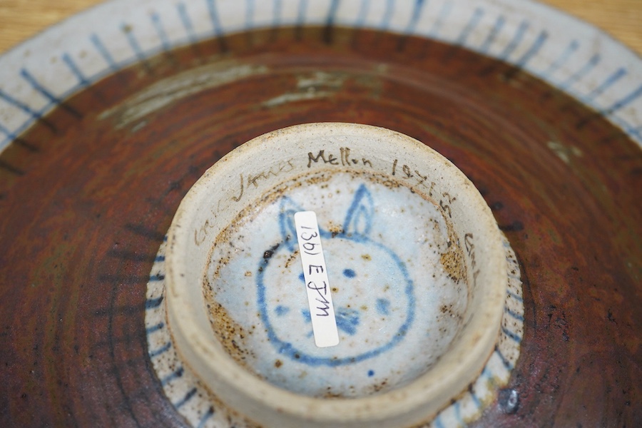 Eric James Mellon (1925-2014), a studio pottery dish, painted with a girl and cat, inscribed and dated 1971 to the foot rim, 29cm in diameter
